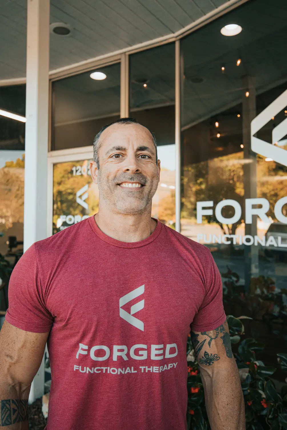 Corey Church, fitness coach, smiling and ready to help clients reach their health goals.