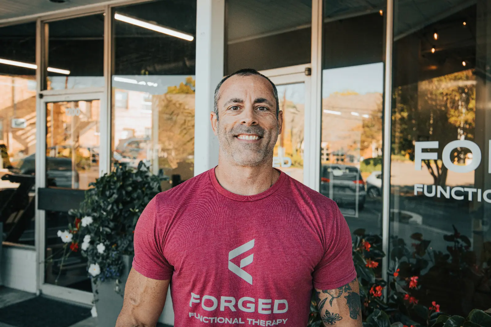 Personal trainer Corey Church smiling confidently at Forged Functional Therapy in Knoxville, TN.
