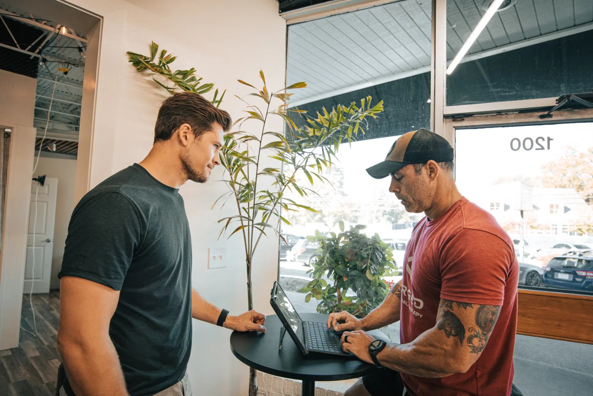 Personal trainer Corey Church guiding a client through a workout session in Knoxville, TN.
